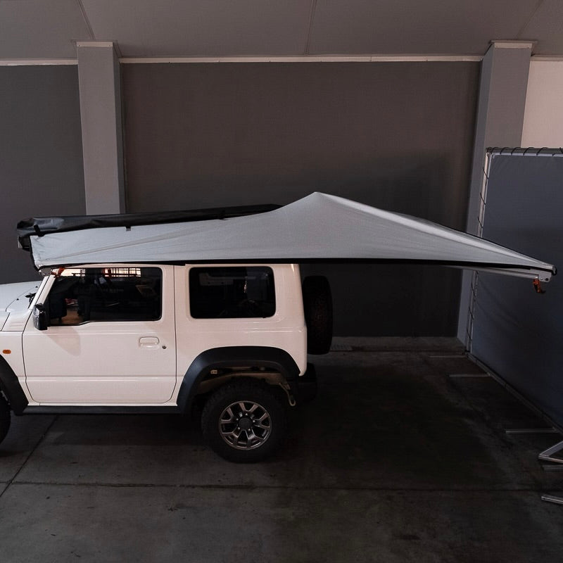Alu-Cab 2 metre 270 degree Shadow Awning mounted to a compact vehicle setup